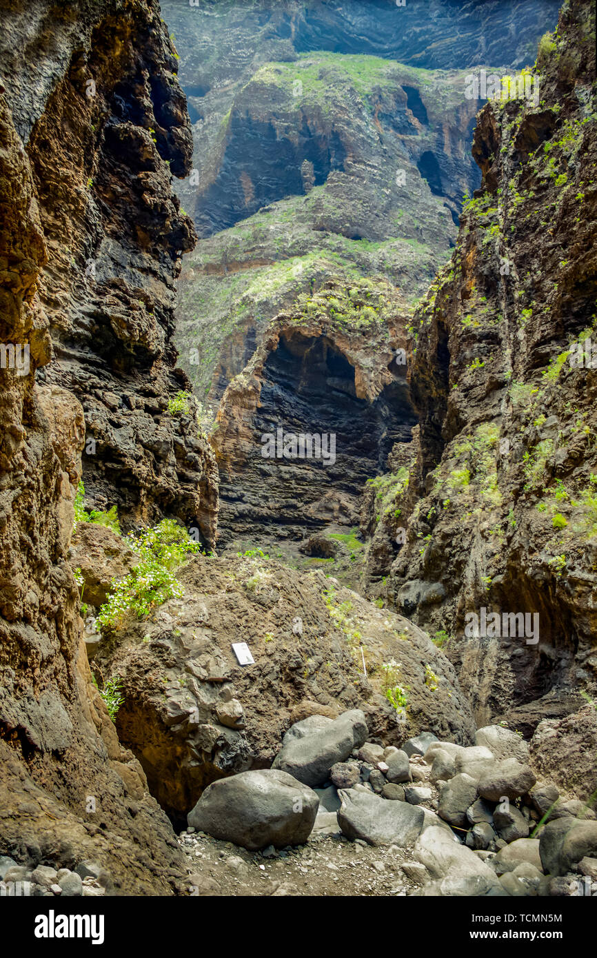 Rocks in the Masca gorge, Tenerife, showing solidified volcanic lava flow  layers and arch formation. The ravine or barranco leads down to the ocean  fr Stock Photo - Alamy
