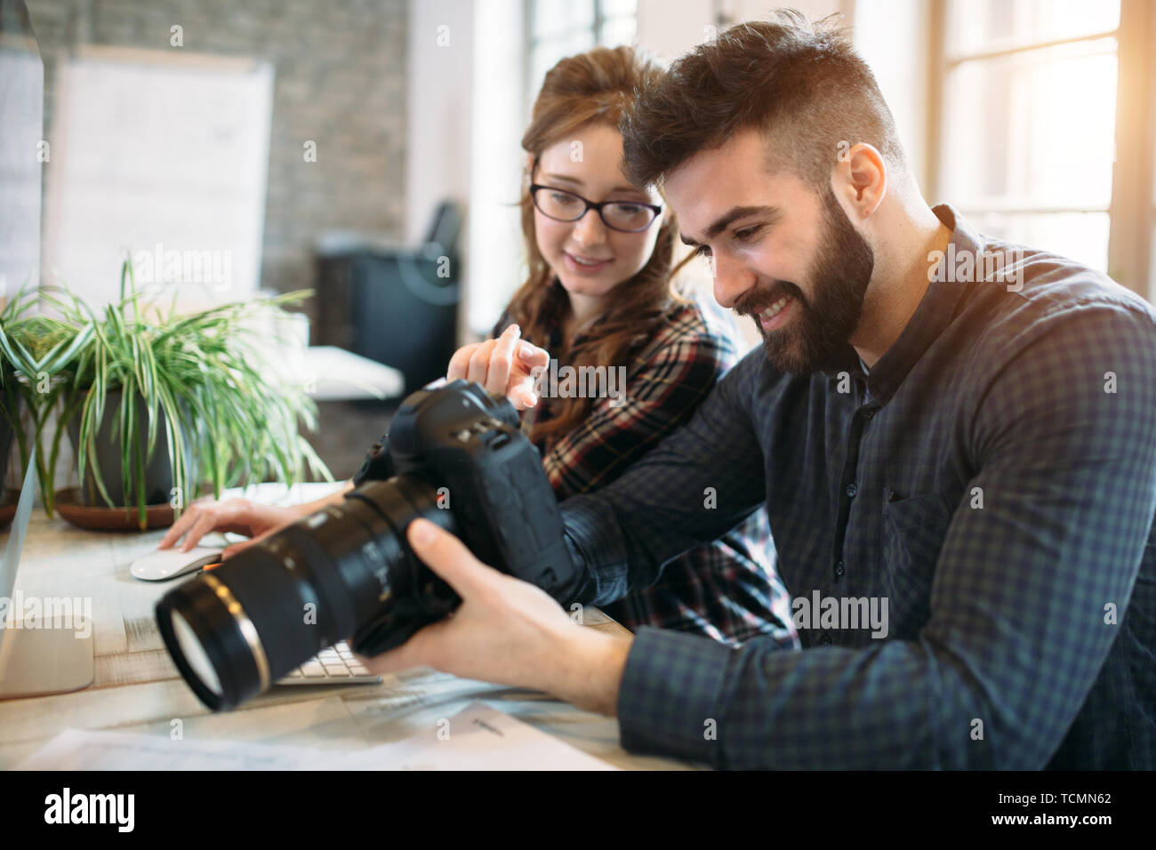 Two young designers working in modern office Stock Photo