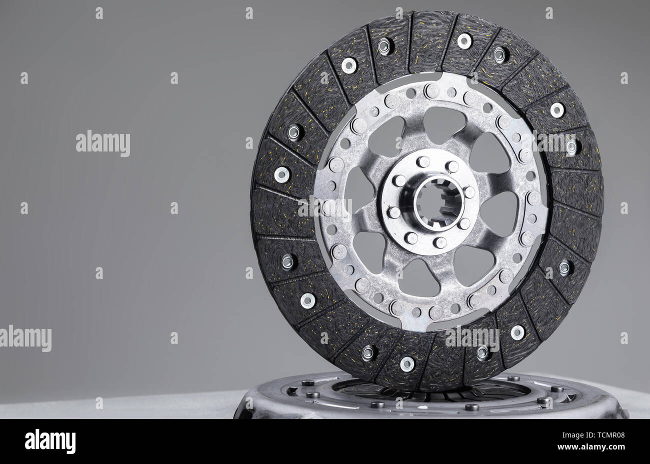 Car clutch plate on a gray background, new part, car warranty service