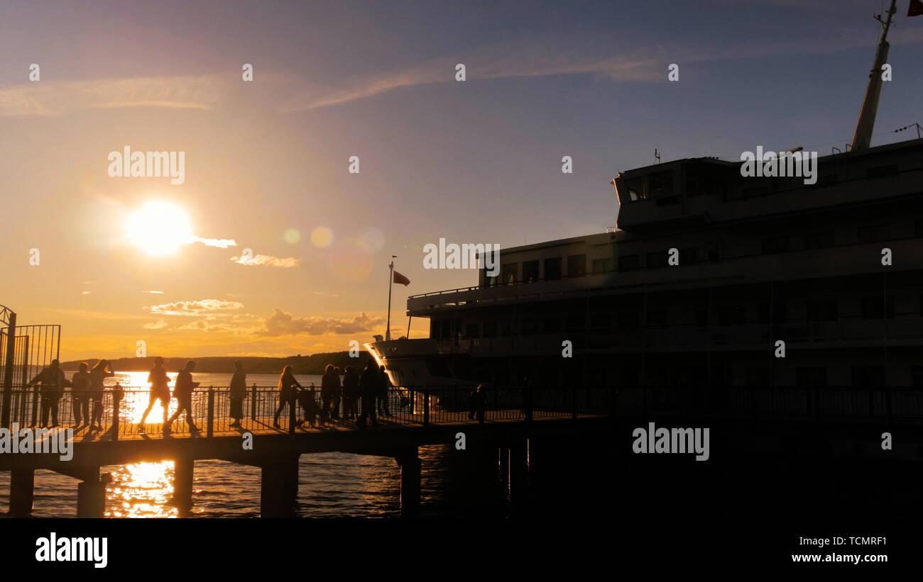 People silhouettes walking on pier Stock Photo - Alamy