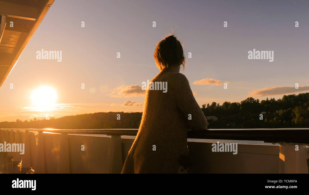 Woman admiring sunset from deck hi-res stock photography and images - Alamy