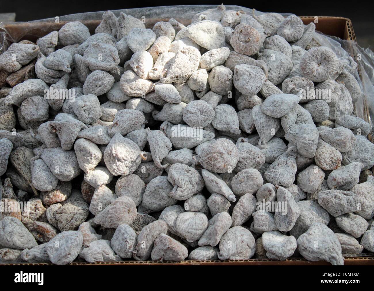 Small cardboard box with dehydrated and sugary figs Stock Photo