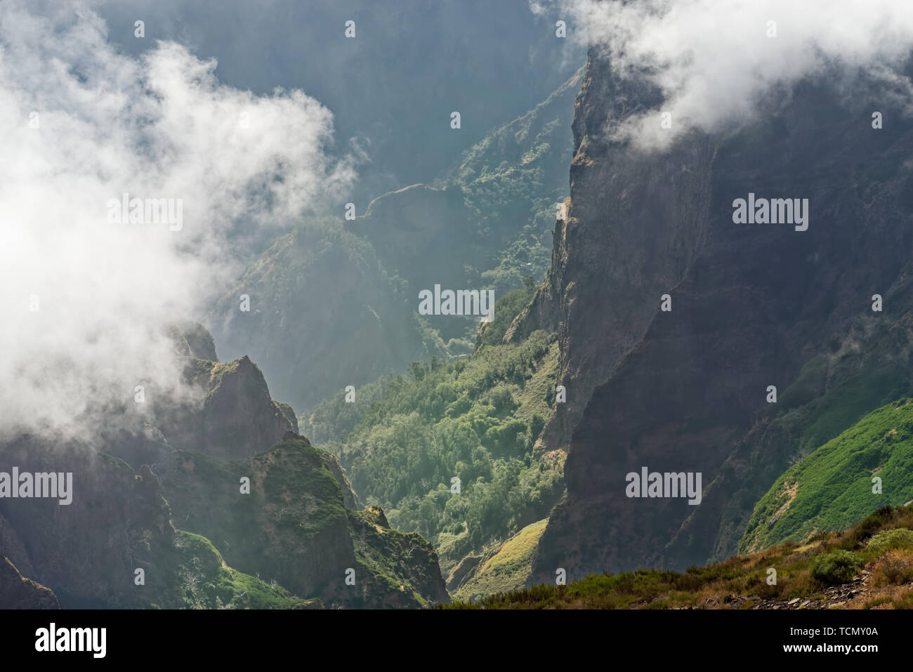 View down from mountain peak at a valley in distant. Pico do Arieiro on Portuguese island of Madeira Stock Photo