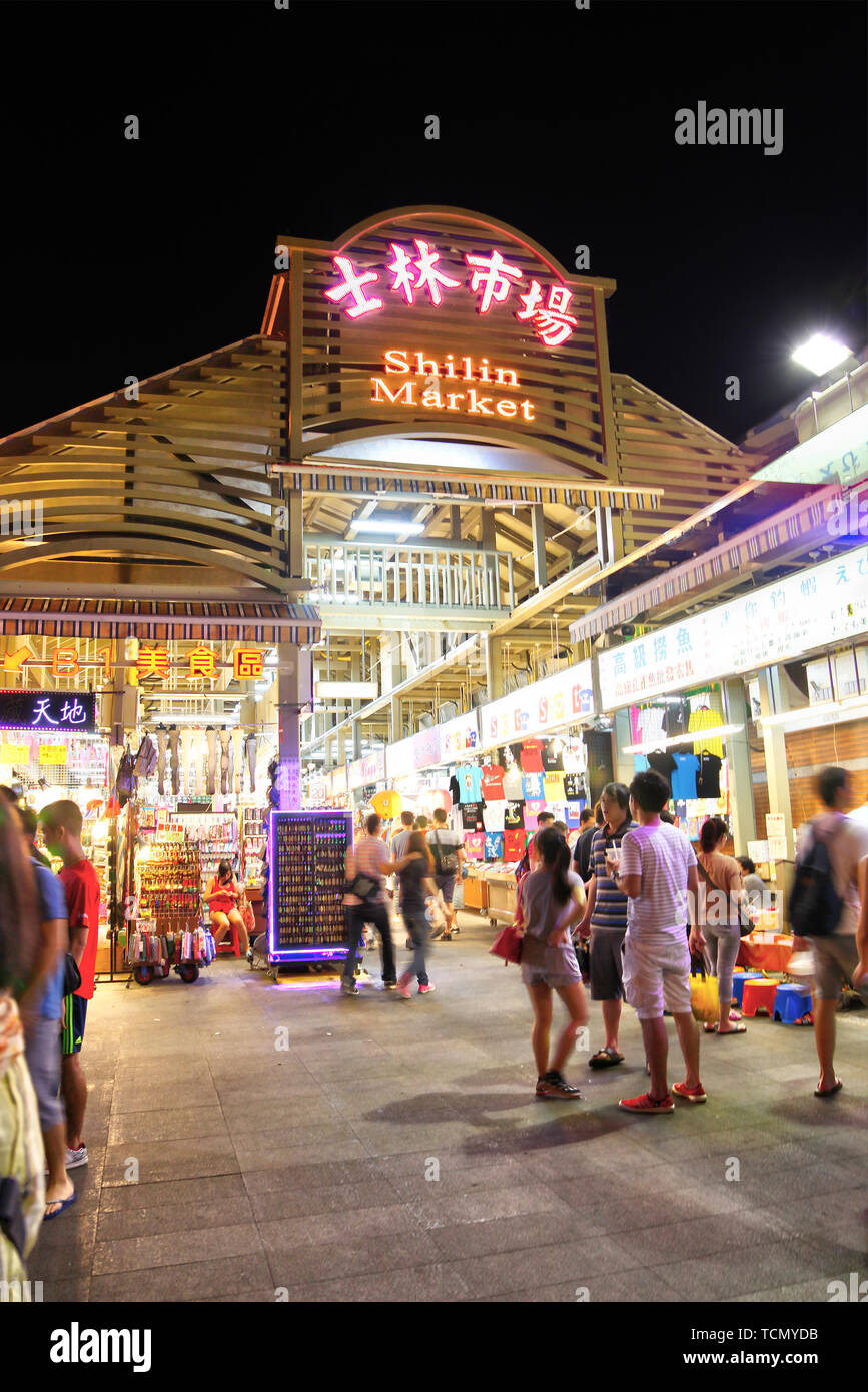 TAIPEI, TAIWAN - July 14, 2013: Crowd mingle at the entrance of Shilin Night Market in the Shilin District of Taipei. Shilin Market is the most popula Stock Photo
