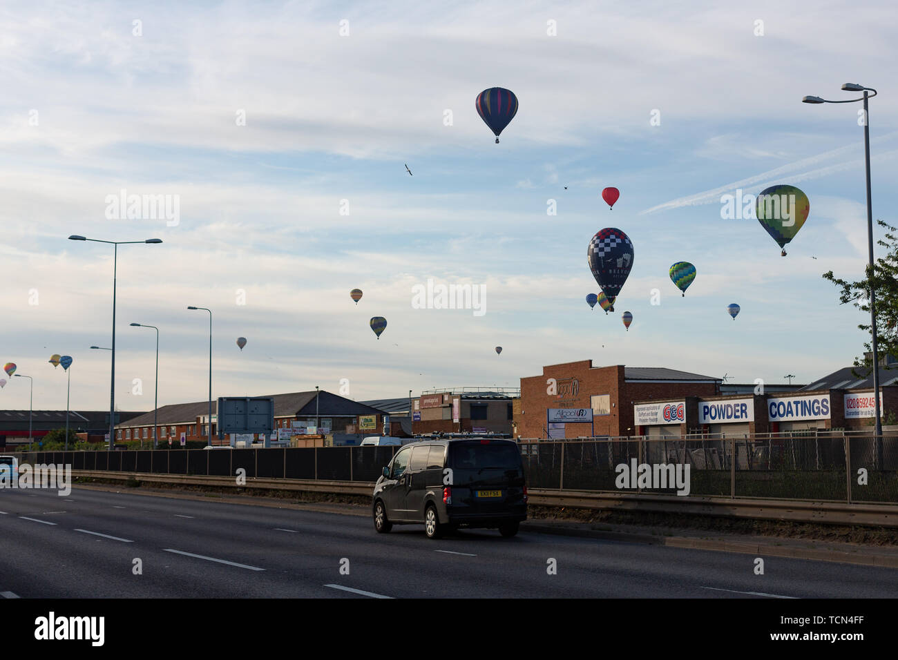 London, UK. 9th June, 2019. Hot air balloons over the A13 at Dagenham. 46 hot air balloons have filled the sky above London this morning as part of the annual Lord Mayor of London's Hot Air Balloon Regatta. The balloons took off from Battersea Park shortly after sunrise and landed in locations around East London and Essex. Credit: Rob Powell/Alamy Live News Stock Photo