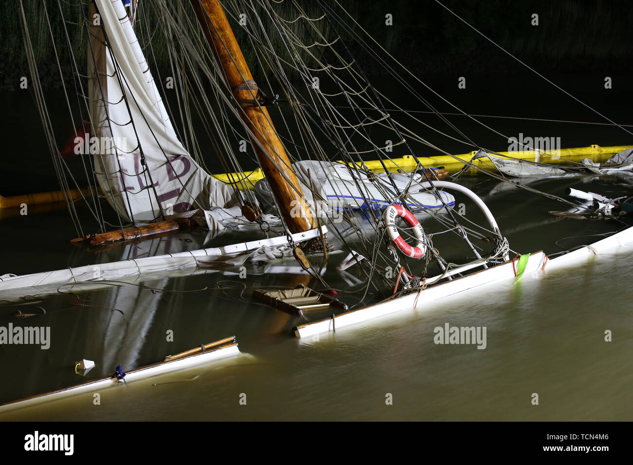 Stadersand, Germany. 08th June, 2019. The sunken historic sailing ship 'No 5 Elbe' rises out of the water in the harbour of Stadersand when the water level drops. The historical sailing ship, which has only recently been extensively renovated, collided with a container ship on the Elbe and sank. Five people were injured in the accident in Stade on Saturday, one of them a woman, according to the Hamburg police. Credit: Bodo Marks/dpa/Alamy Live News Stock Photo