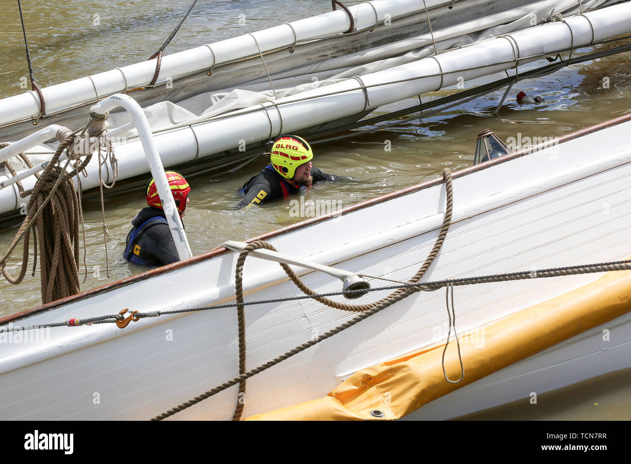 Stadersand, Germany. 09th June, 2019. DLRG employees are working on the sunken historic sailing ship 'No 5 Elbe' in the port of Stadersand. The historical sailing ship, a pilot schooner built in 1883, which was only recently extensively renovated, collided with a container ship on the Elbe and sank. Five people were injured in the accident in Stade on Saturday, one of them a woman, according to the Hamburg police. Credit: Bodo Marks/dpa/Alamy Live News Stock Photo