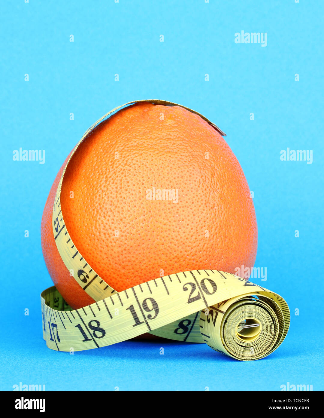 https://c8.alamy.com/comp/TCNCFB/orange-with-measuring-tape-on-blue-background-TCNCFB.jpg