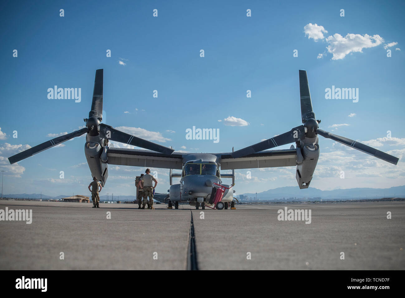 Maintenance and pilots prepare to deplane a V-22 Osprey, June 5, 2019, at Nellis Air Force Base, Nev. Nellis AFB is frequently visited by a multitude of different units and aircraft as it is the home of U.S. Air Force Weapons School, as well as Green Flag and Red Flag exercises. (U.S. Air Force photo by Airman 1st Class Jeremy Wentworth) Stock Photo