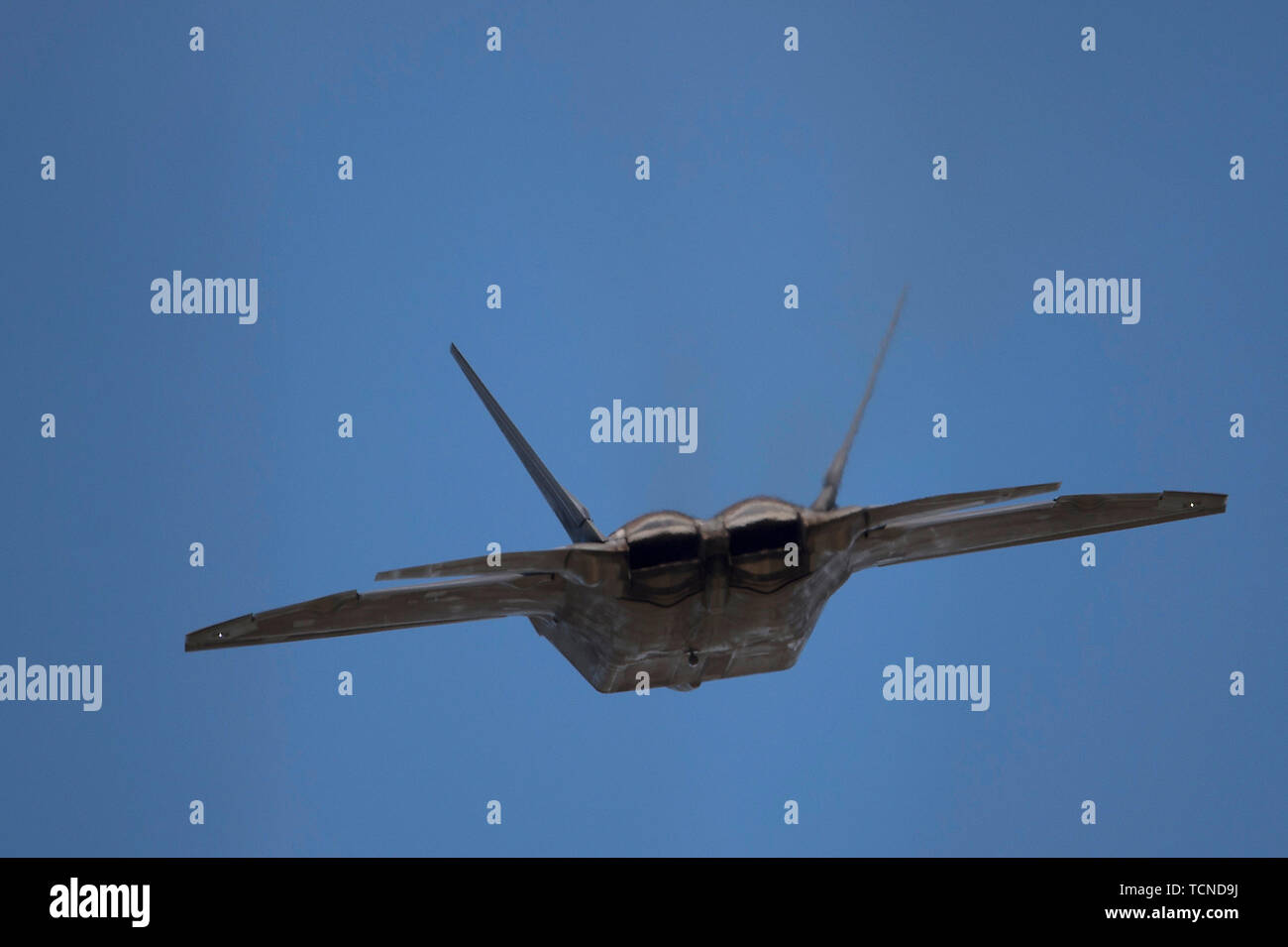 A U.S. Air Force F-22 Raptor assigned to the 525th Fighter Squadron takes off from Joint Base Elmendorf-Richardson, Alaska, during a training sortie with several F/A-18Es from Strike Fighter Squadron 192, June 6, 2019. VFA-192 set up a detachment of F/A-18Es in Alaska to provide integration and support training with JBER's F-22 Raptors. VFA-192's Alaska detachment allows pilots the opportunity to increase their tactical and strategic skills in a joint combat environment. (U.S. Air Force photo by Staff Sgt. James Richardson) Stock Photo