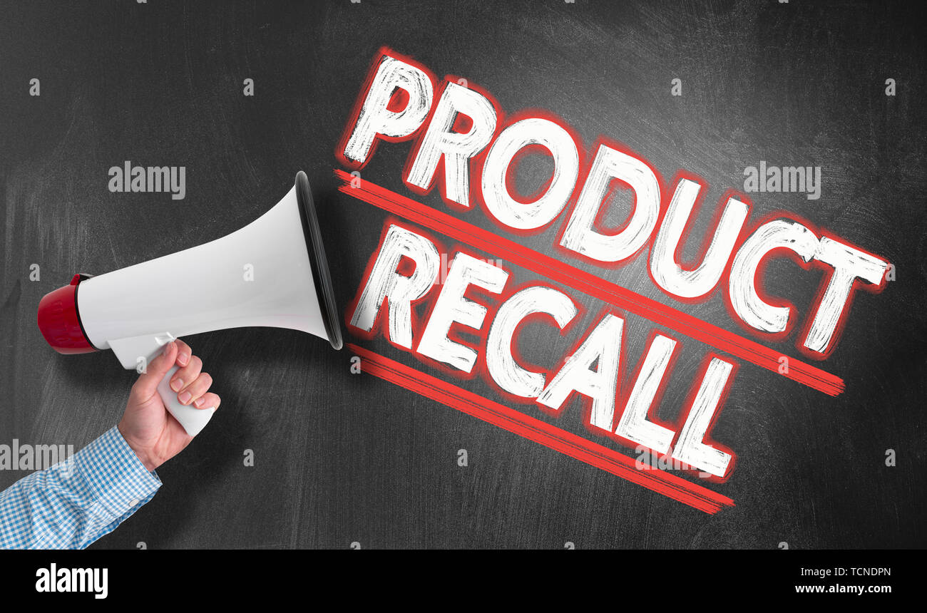 hand holding megaphone or bullhorn against blackboard with text PRODUCT RECALL Stock Photo
