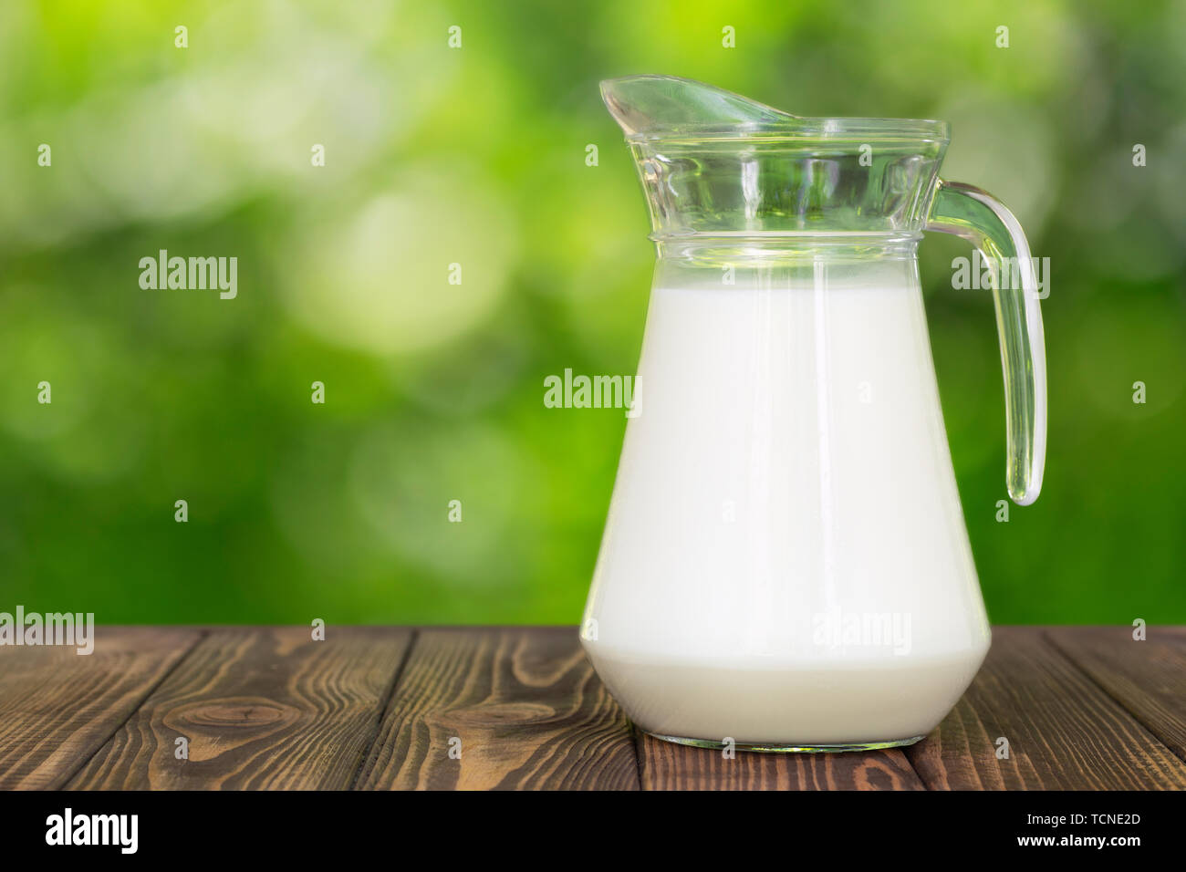milk in glass jug on table Stock Photo