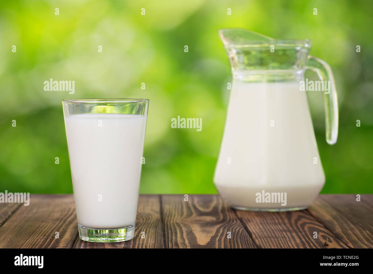 milk in glass and jug on table Stock Photo