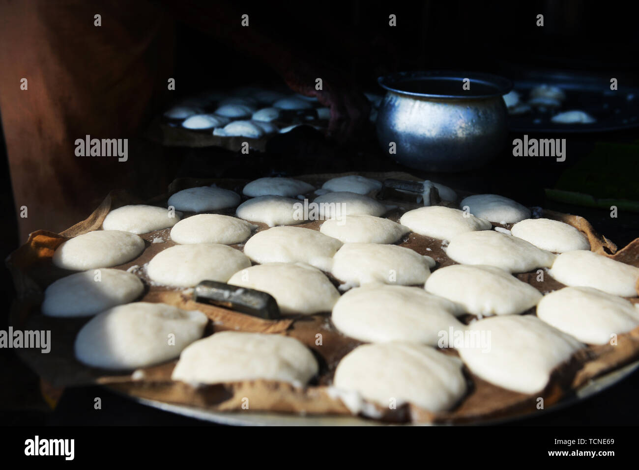 Idly ( savoury rice cake ) preparation. Stock Photo