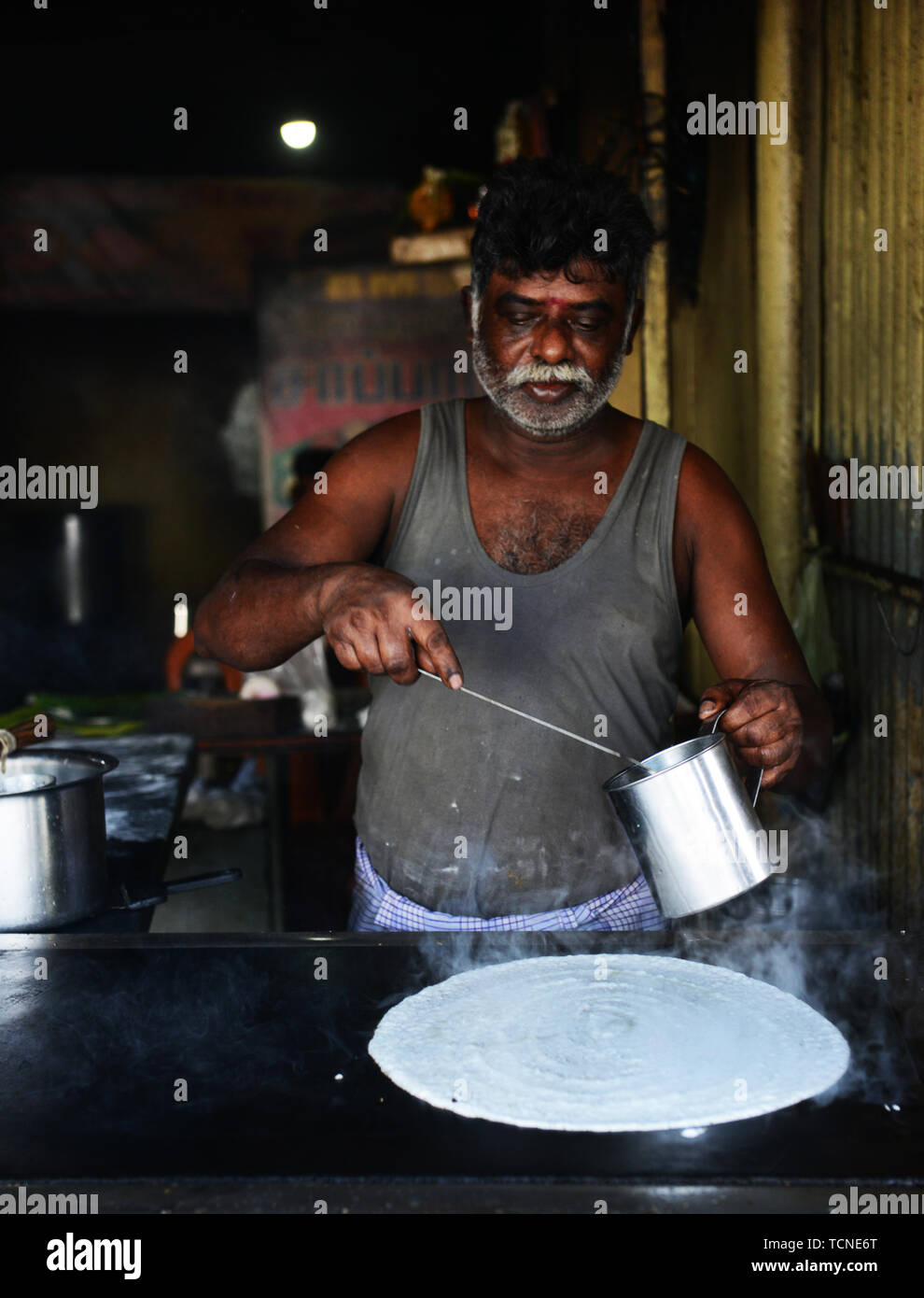 A Tamil cook preparing a Dosa Stock Photo Alamy A Tamil cook preparing a Dosa Stock Photo Alamy