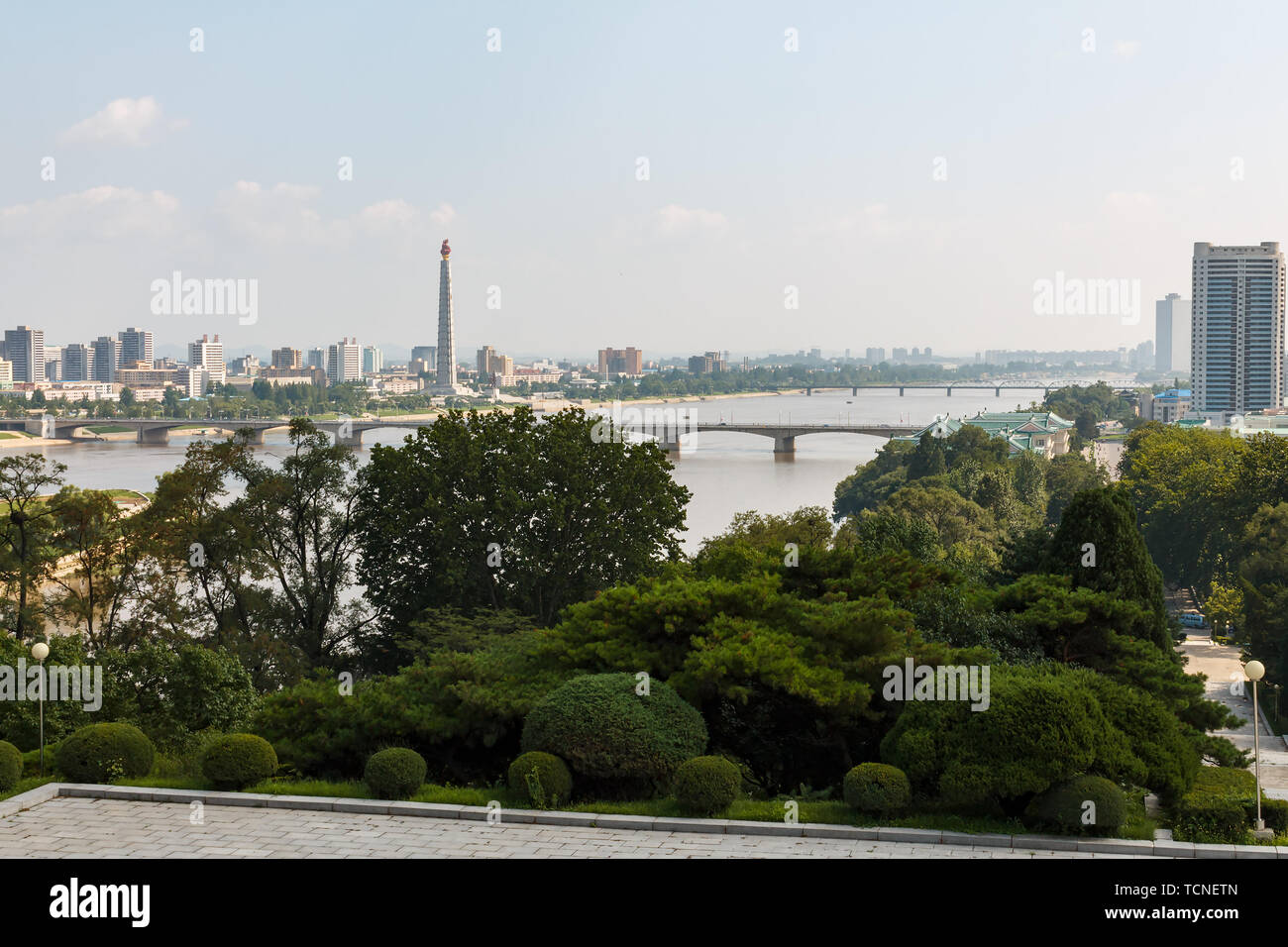 Pyongyang, North Korea - July 27, 2019: View of the Pyongyang city and the Teadong River. Tower of the Juche Ideology in the Pyongyang. Stock Photo