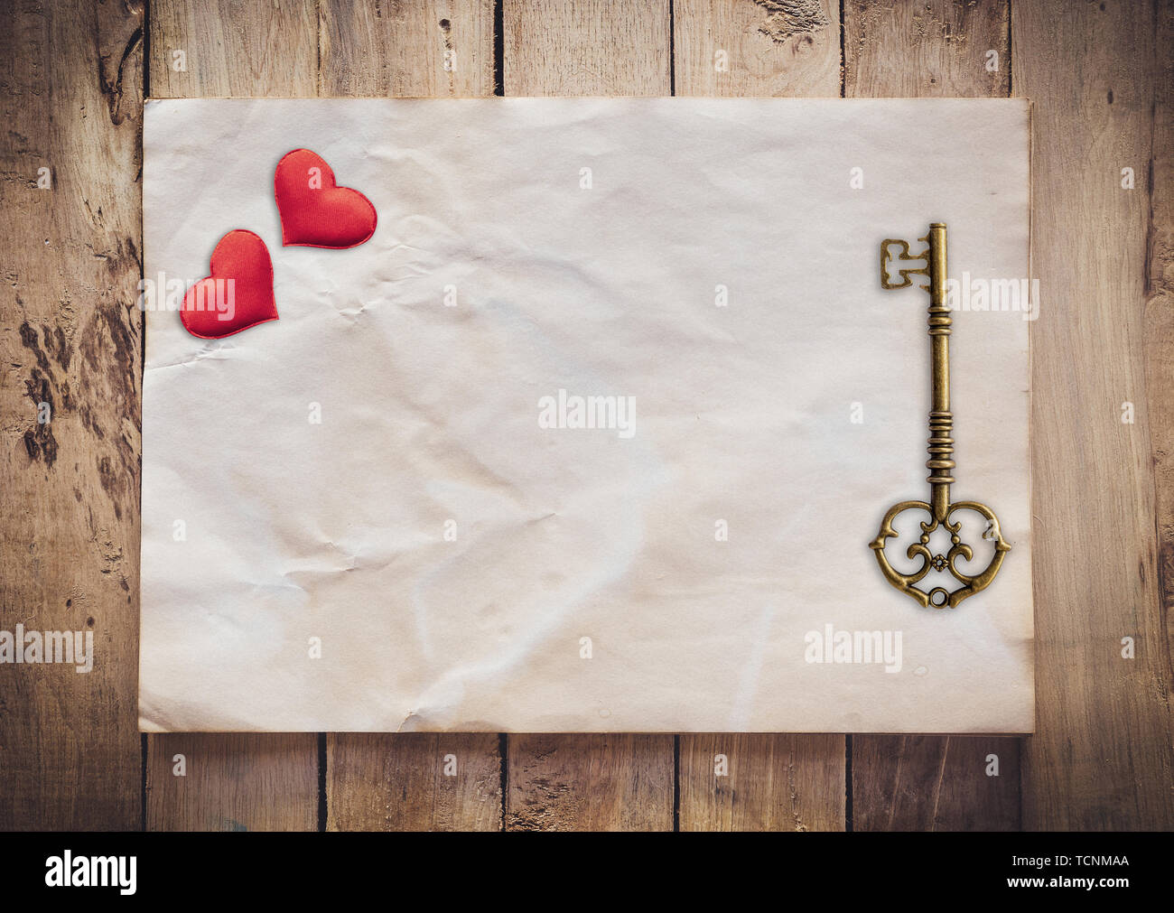 Old key and red heart on Old paper vintage on wood background with ...