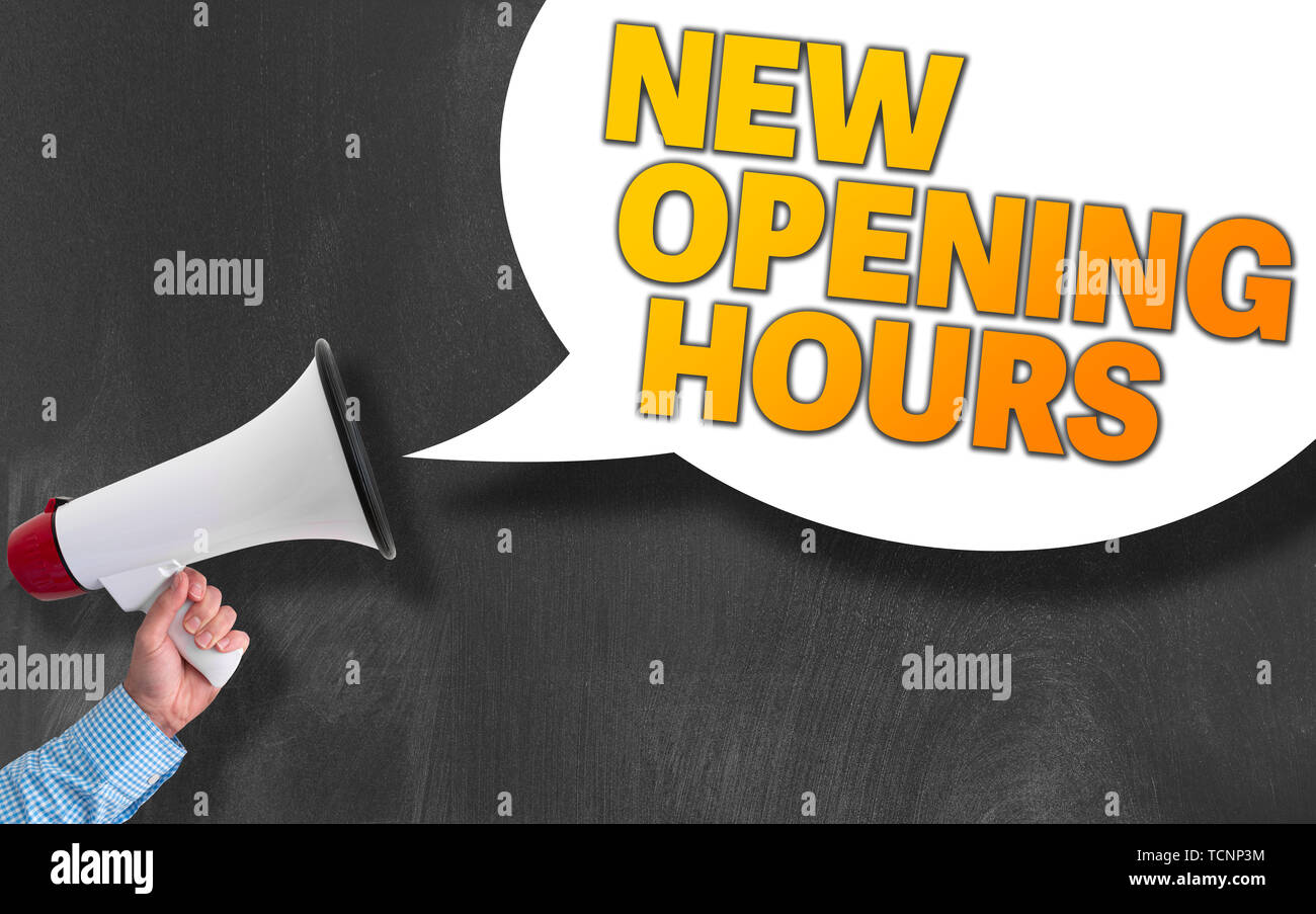 hand of businessman holding megaphone or bullhorn against blackboard with text NEW OPENING HOURS