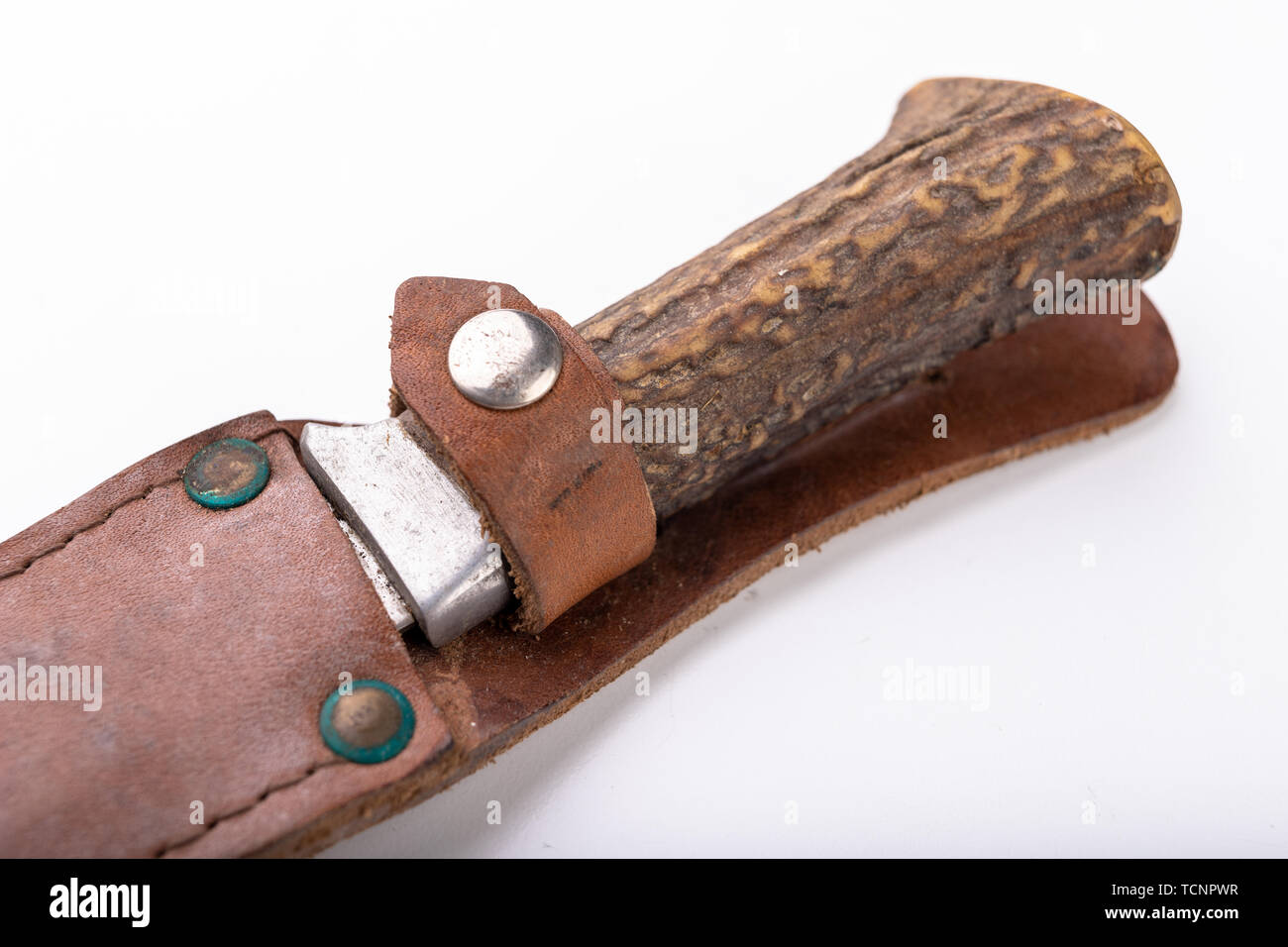 An old little dirty hunting knife on a white table. Hunting accessories  needed for hunting big game. Light background Stock Photo - Alamy