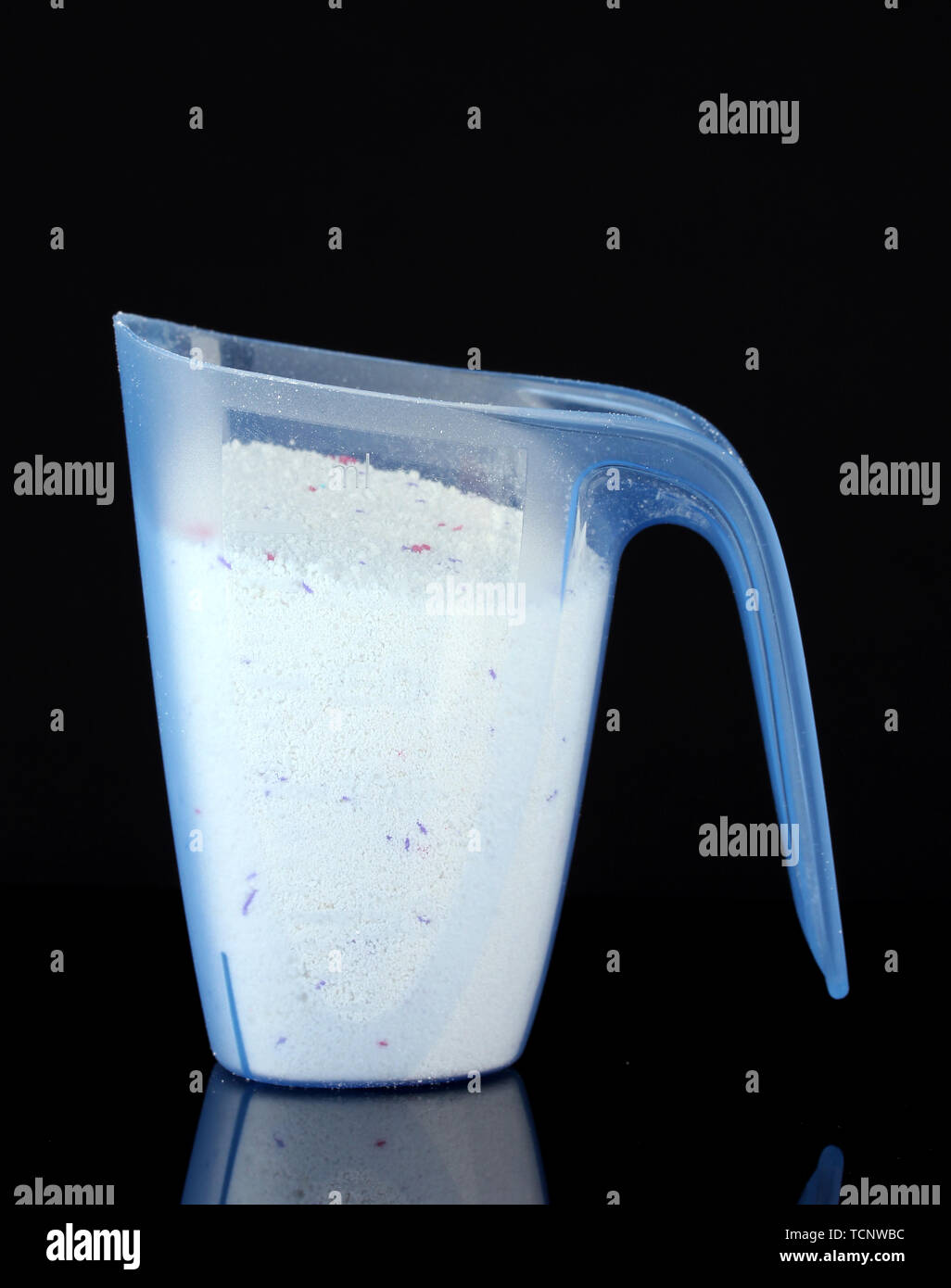 https://c8.alamy.com/comp/TCNWBC/washing-powder-in-a-measuring-cup-isolated-on-black-TCNWBC.jpg