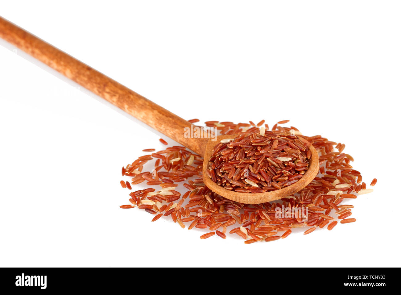 red rice in wooden spoon isolated on white background Stock Photo - Alamy