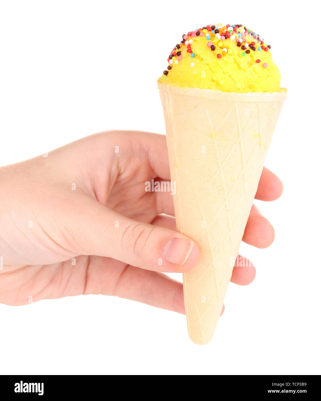 Scoop of lemon ice cream in the waffle cone decorated with sprinkles