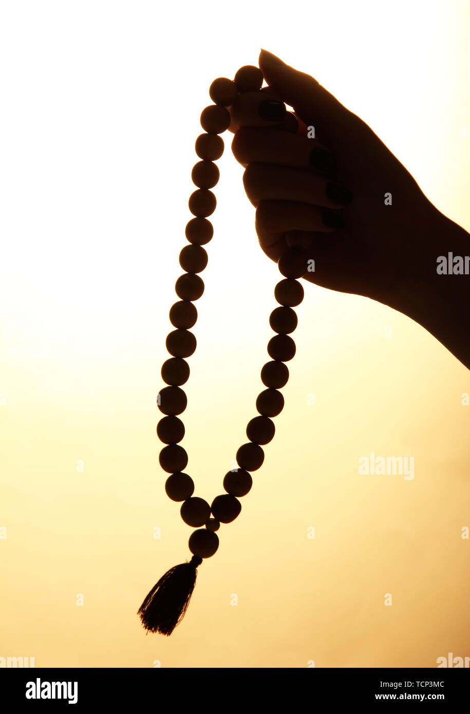 female hands with rosary, on beige background Stock Photo - Alamy