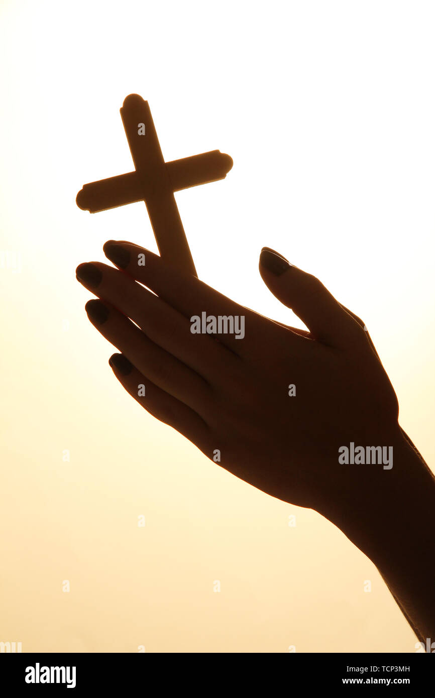 female hands with crucifix, on beige background Stock Photo - Alamy