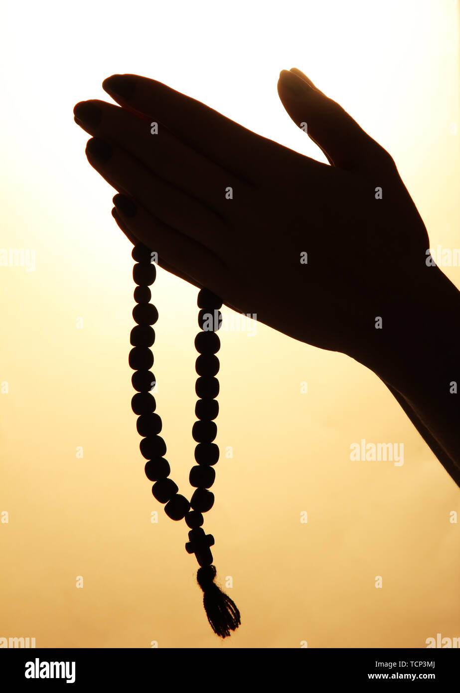 female hands with rosary, on beige background Stock Photo - Alamy