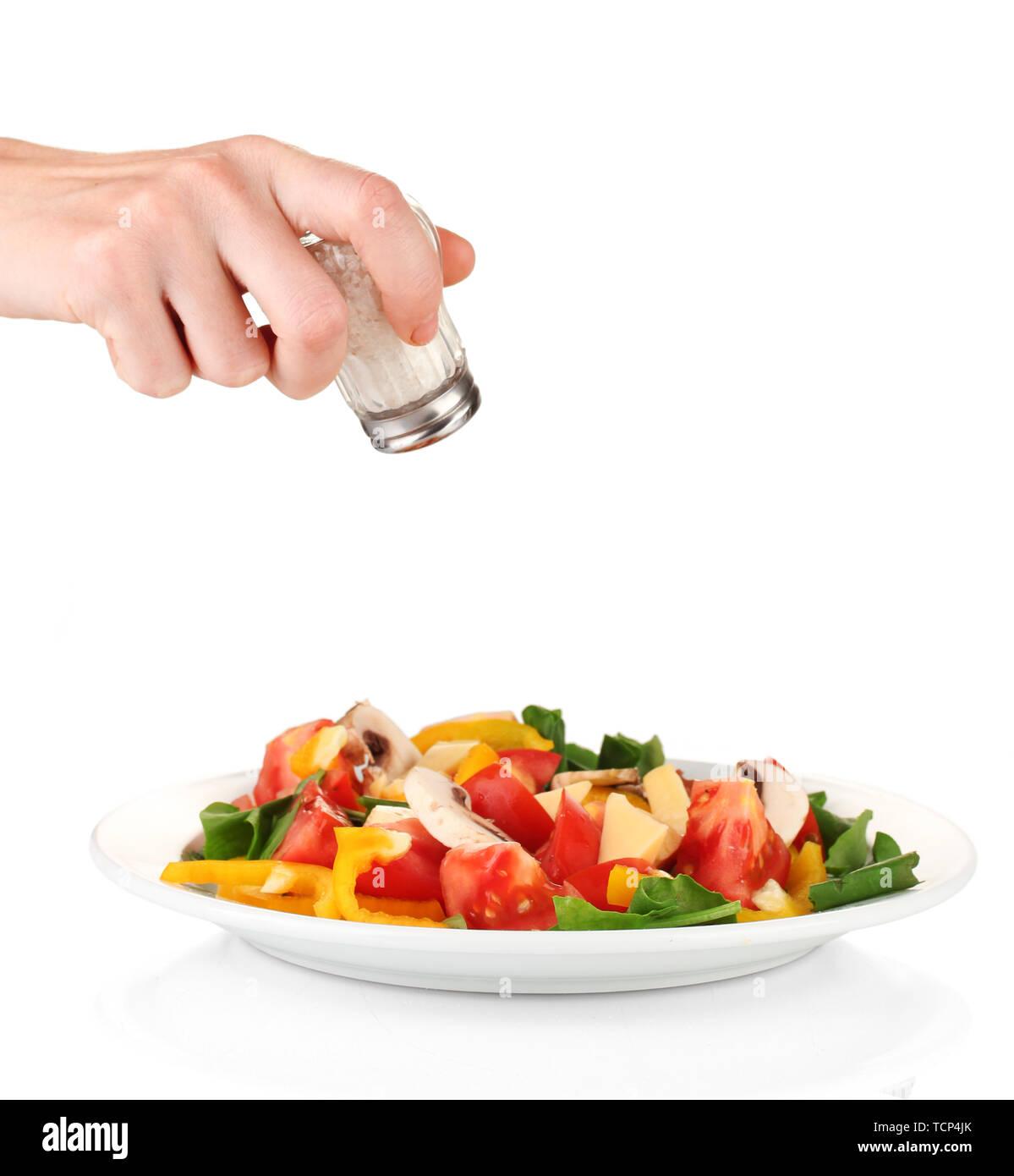 Hand adding salt using salt shaker isolated on white Stock Photo Alamy