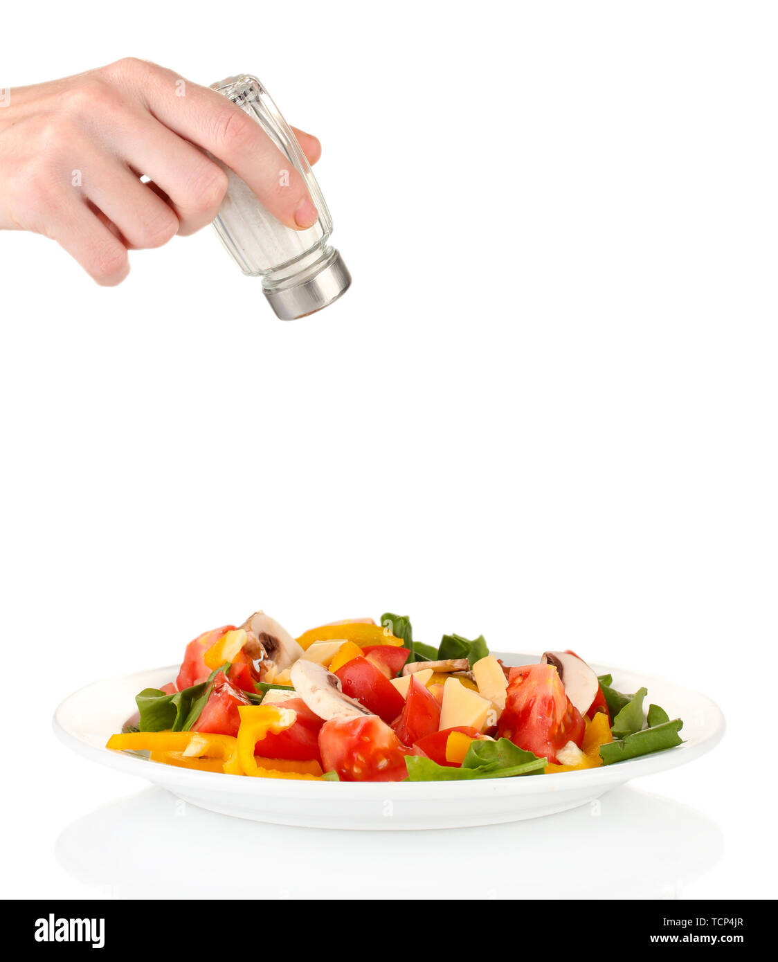 Hand adding salt using salt shaker isolated on white Stock Photo Alamy
