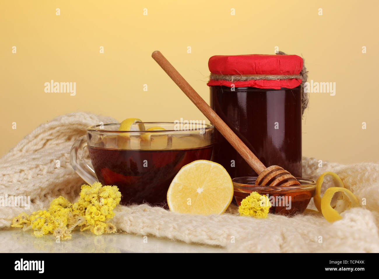 Healthy ingredients for strengthening immunity on warm scarf on yellow background Stock Photo