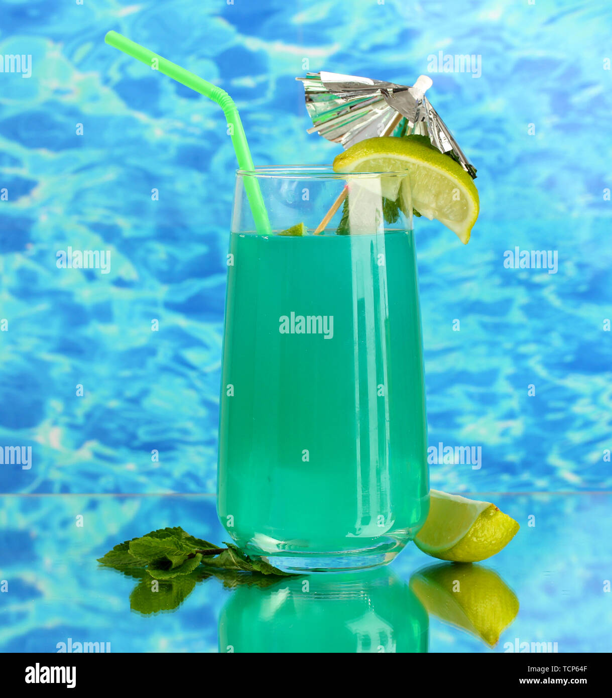 Glass of blue cocktail on blue background Stock Photo - Alamy