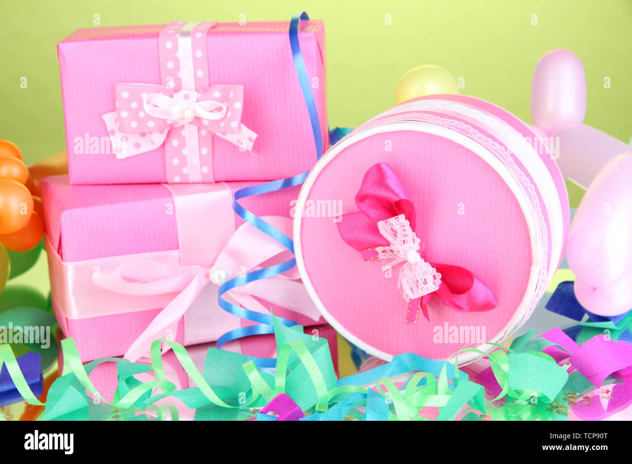 Colorful gift boxes on green background Stock Photo - Alamy