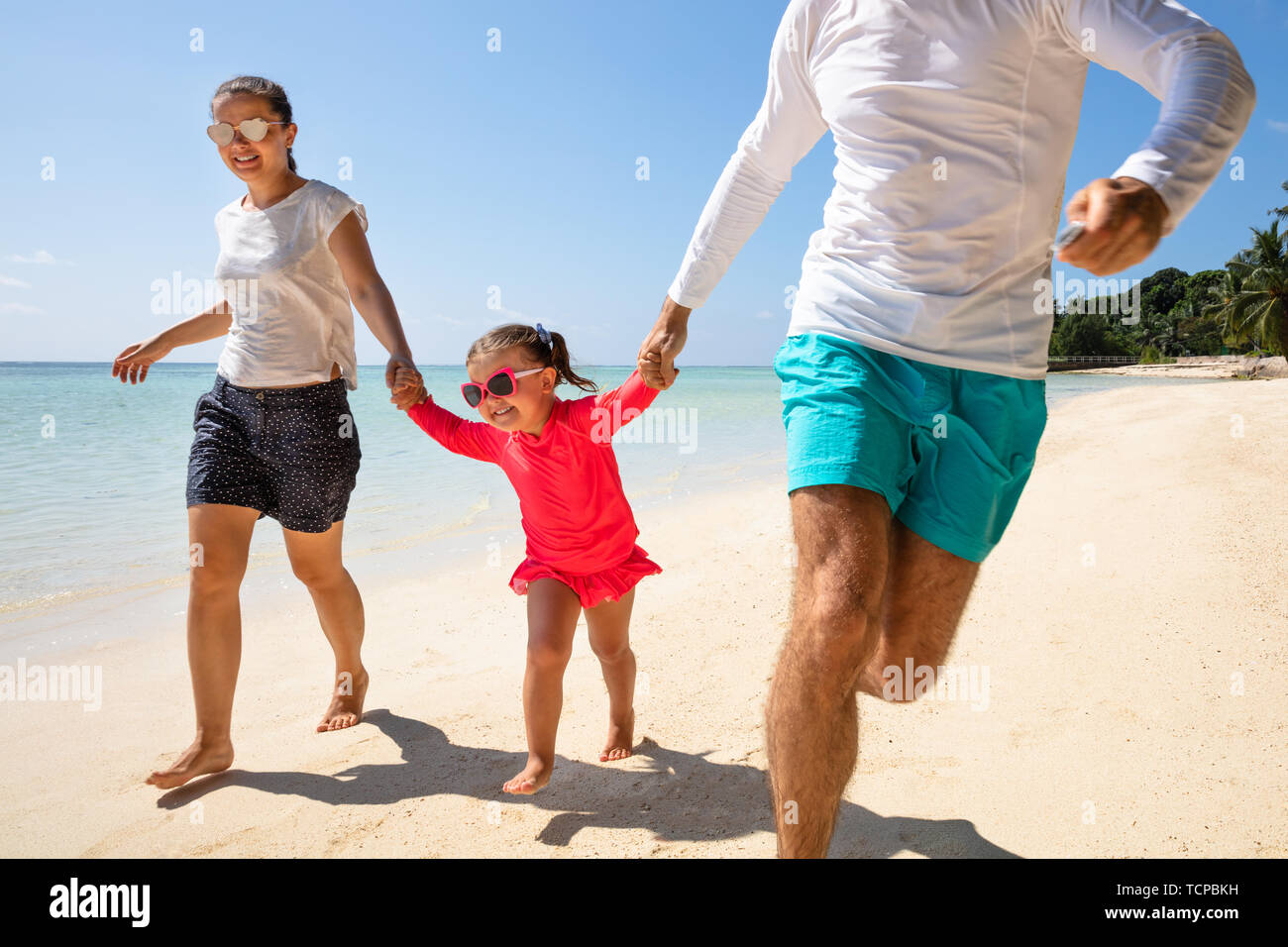 Happy family running on beach hi-res stock photography and images - Alamy