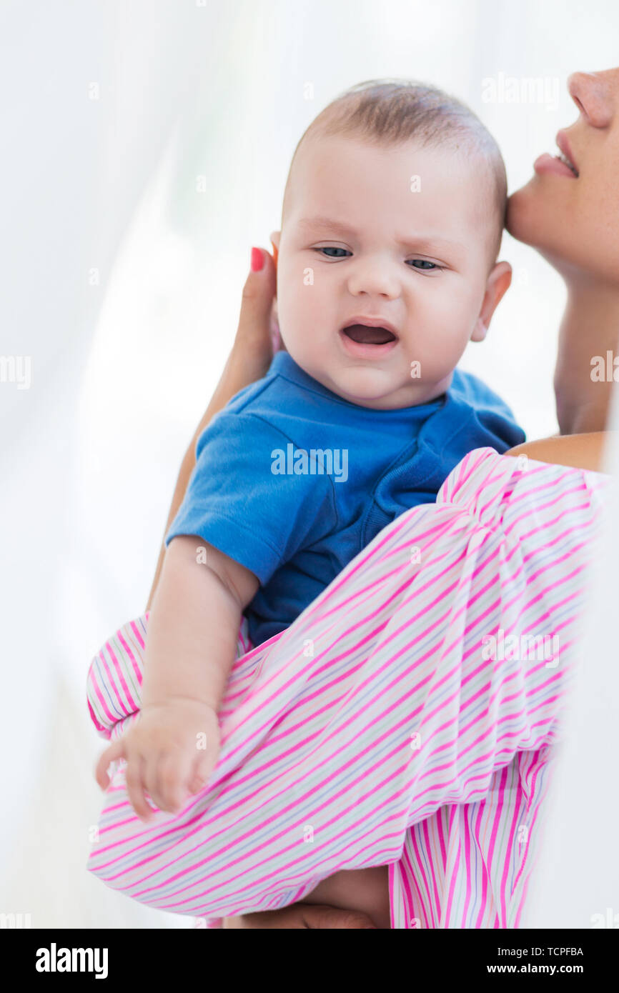 Woman holding tired little boy hires stock photography and images Alamy