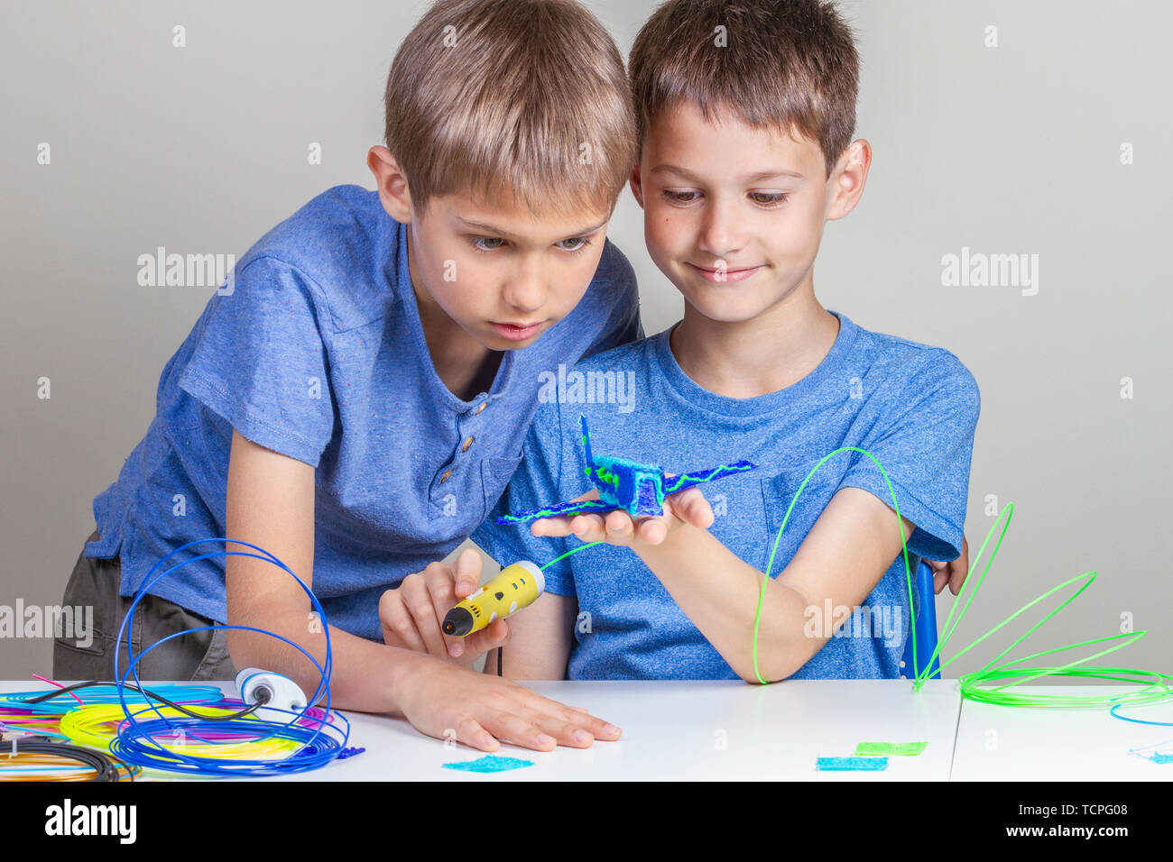 Two boys creating with 3d printing pens Stock Photo - Alamy