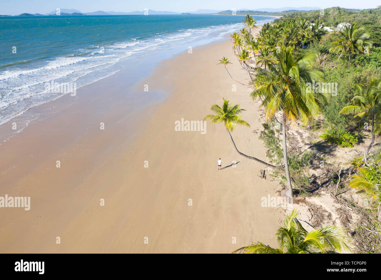 Aerial top view of beach with white sand, beautiful palm trees and warm turquoise tropical water in tropical paradise island, tropics Stock Photo