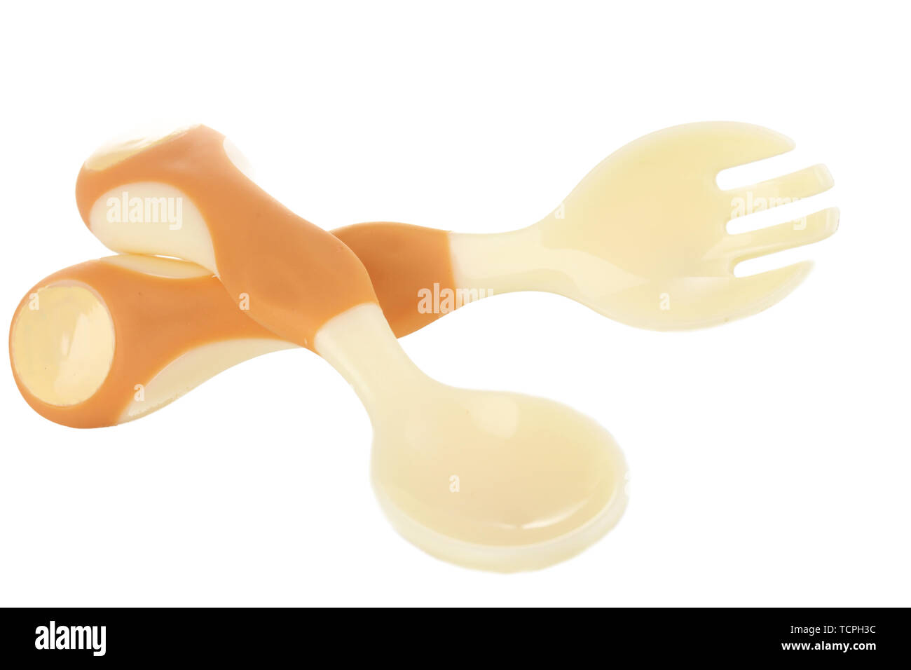 Small beige spoon and fork for babies isolated on white Stock Photo