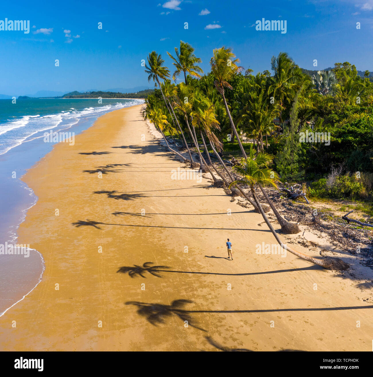 Aerial top view of beach with white sand, beautiful palm trees and warm turquoise tropical water in tropical paradise island, tropics Stock Photo