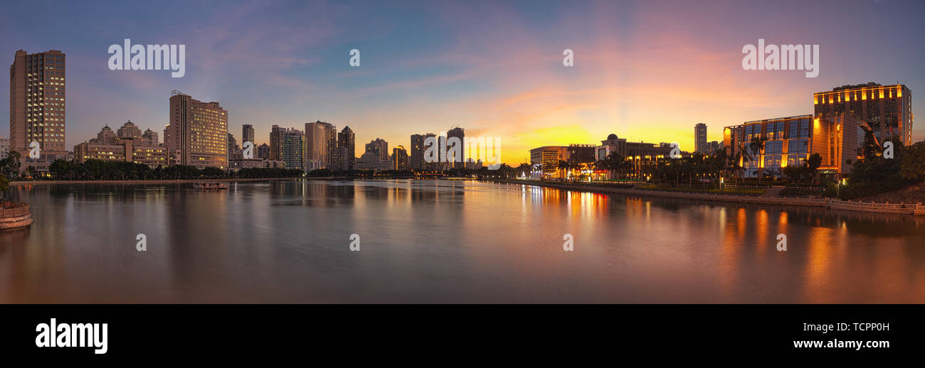 Egret Chau is located on the shores of Lake Lottery, with the water standing in the high-rise building and the hotel, along with the dusk, outline the city appearance of the bustling Xiamen. Stock Photo