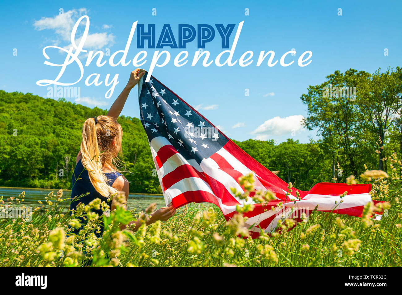 Happy Independence day, 4th of July. Young woman holding American flag. Stock Photo