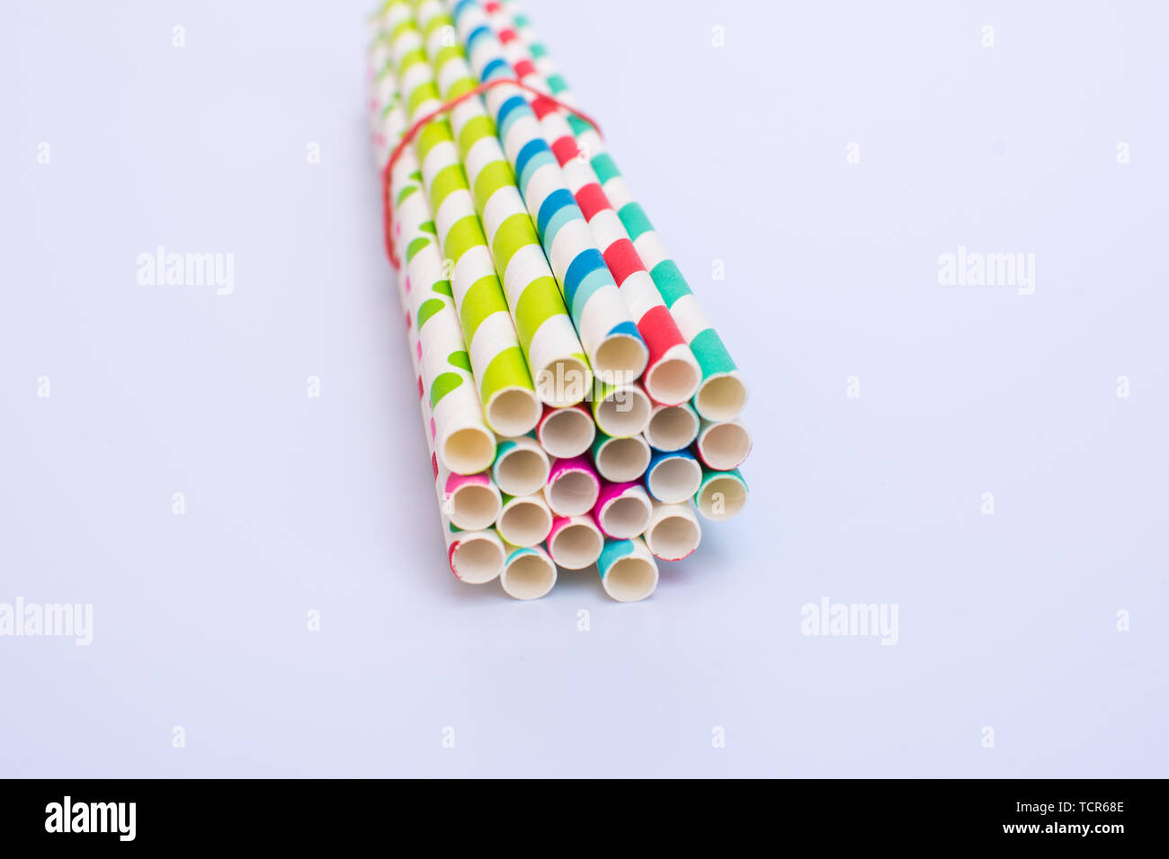 Paper straws bundled up on a white background Stock Photo