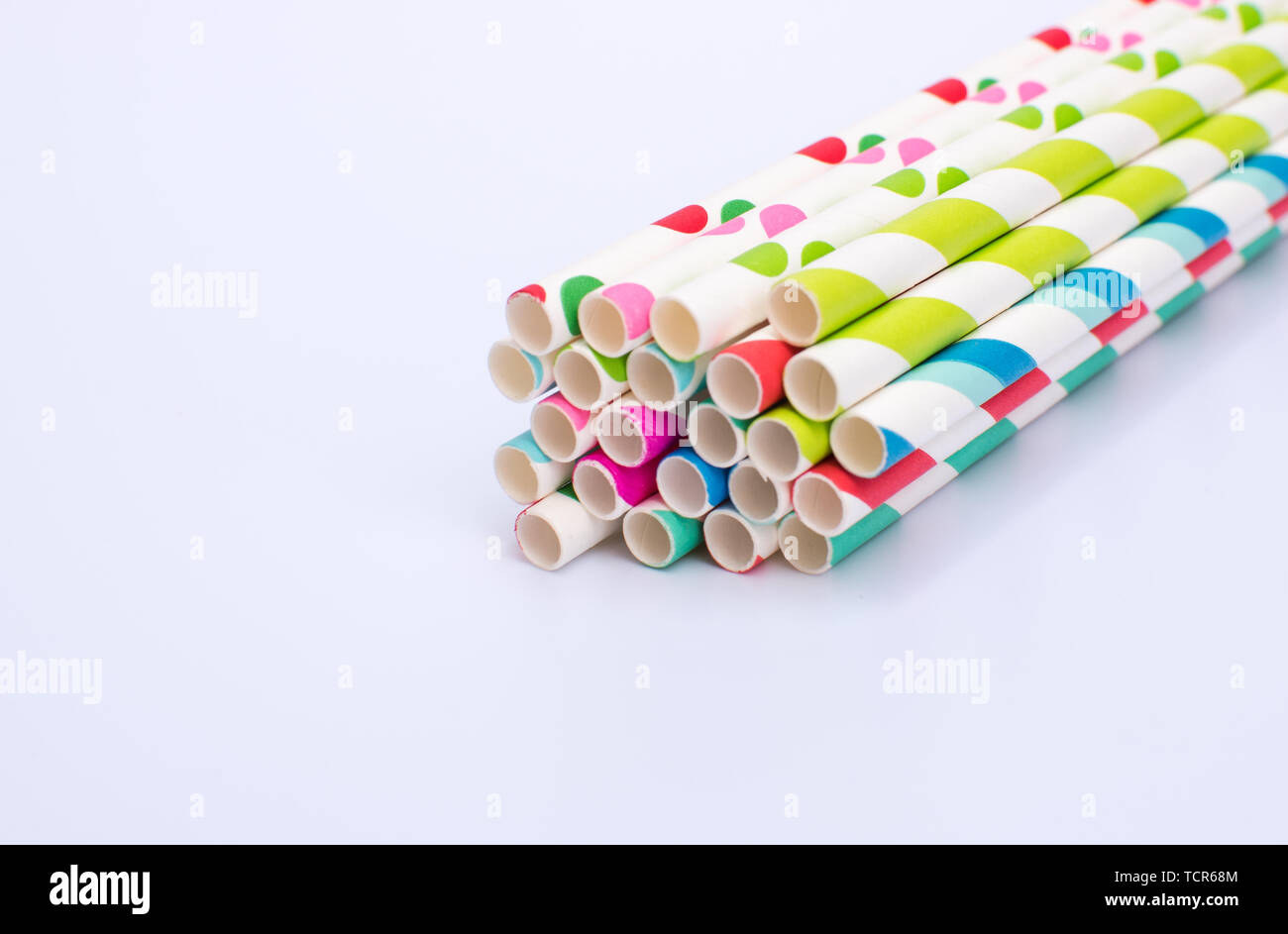 Paper straws bundled up on a white background Stock Photo
