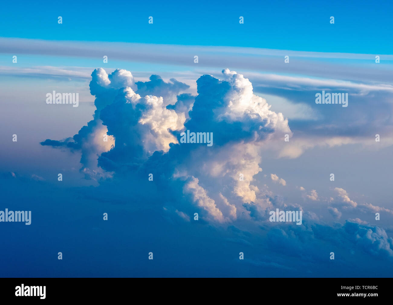Dramatic Cumulonimbus cloud formations at sunset taken from an aircraft window over southern europe. Stock Photo