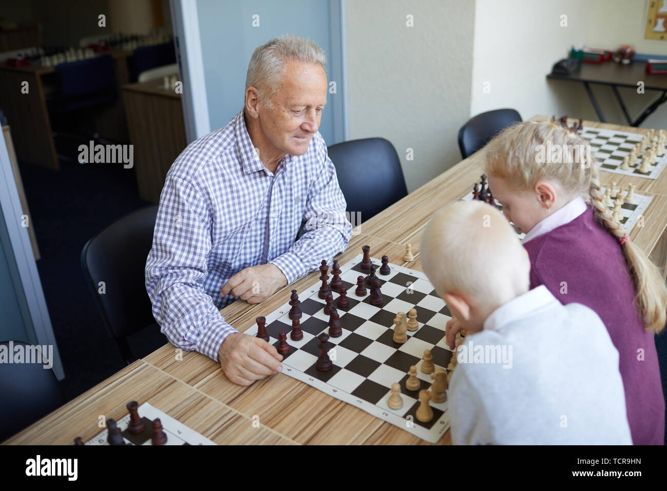 Teenager Playing Chess with his Grandfather · Free Stock Photo