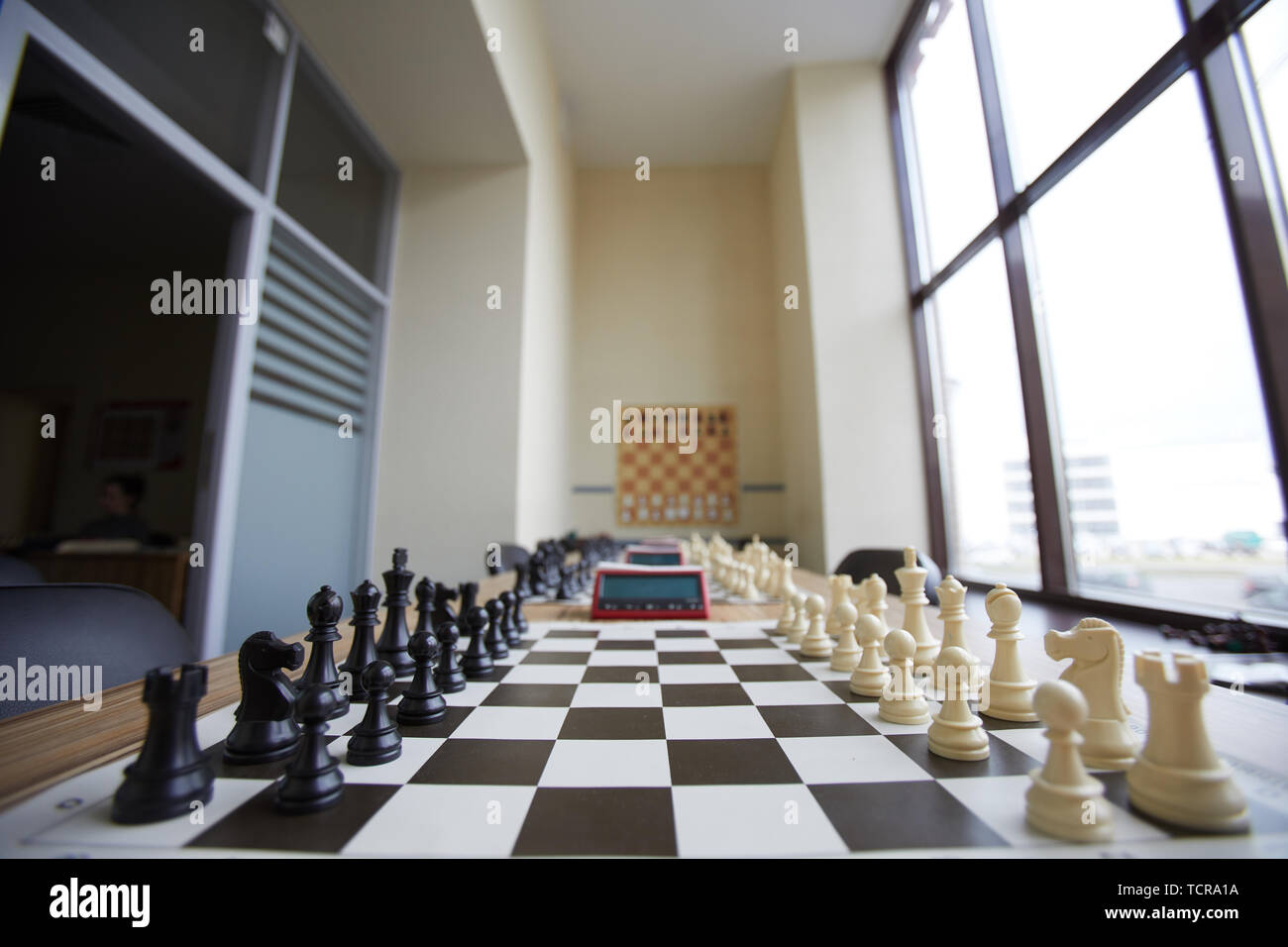 Chess club classroom well prepared for classes with long table, several chess boards and big window Stock Photo