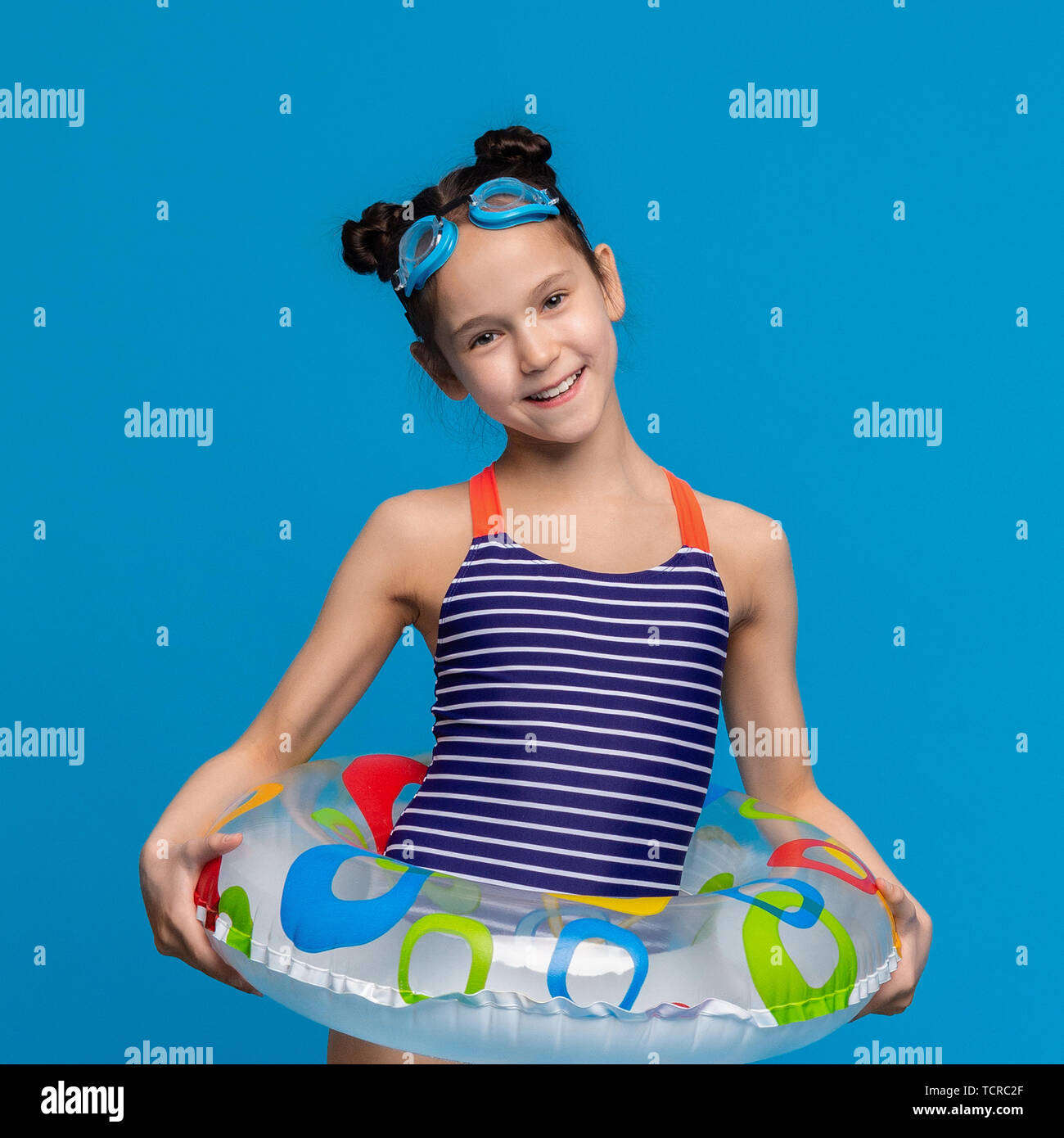 Little girl wearing inflatable ring and swim goggles Stock Photo Alamy
