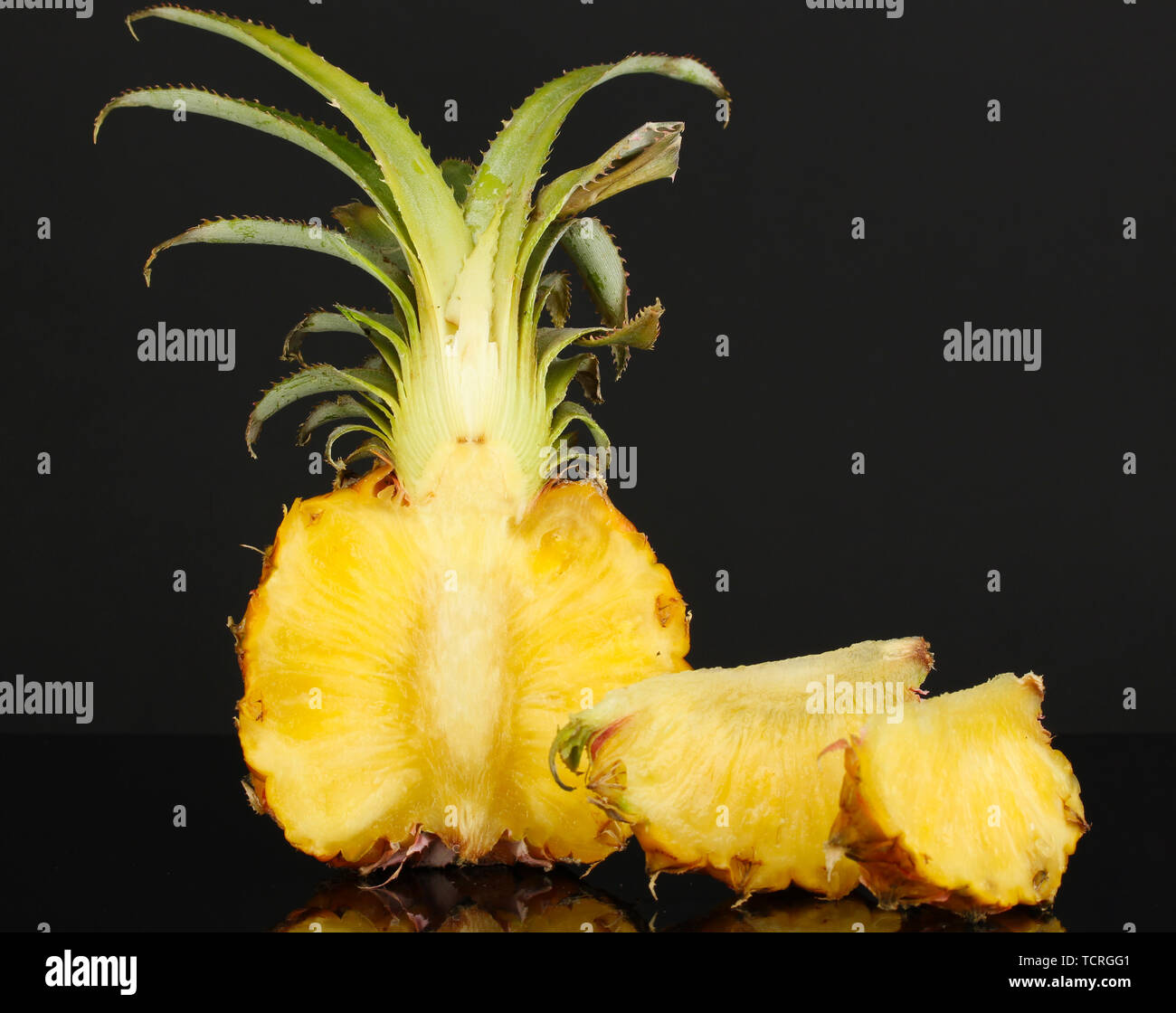 Sliced ripe pineapple isolated on black Stock Photo