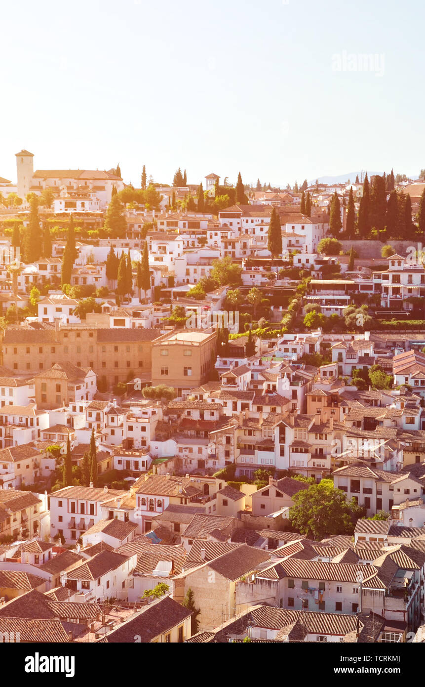 Historical district Albaicin in Spanish Granada captured on a vertical picture from above. The famous part of city is known for its medieval Moorish architecture. Popular tourist spot. Sunset light. Stock Photo